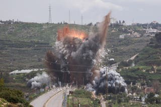 Smoke rises after an Israeli strike on a bridge on Sunday near Qasmiyeh in Lebanon